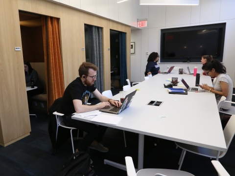 Students work at a table in the Lawyer Leadership Clinic