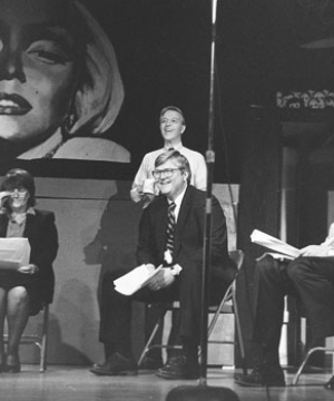 Dean James Milligan seated on a stage